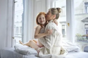 woman with daughter on bed