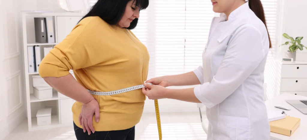 Healthcare professional measuring a patient's waist circumference for Tirzepatide weight loss assessment.