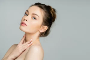Woman with glowing skin after HydraFacials treatment.