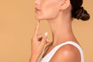 Side profile of woman touching chin with defined jawline